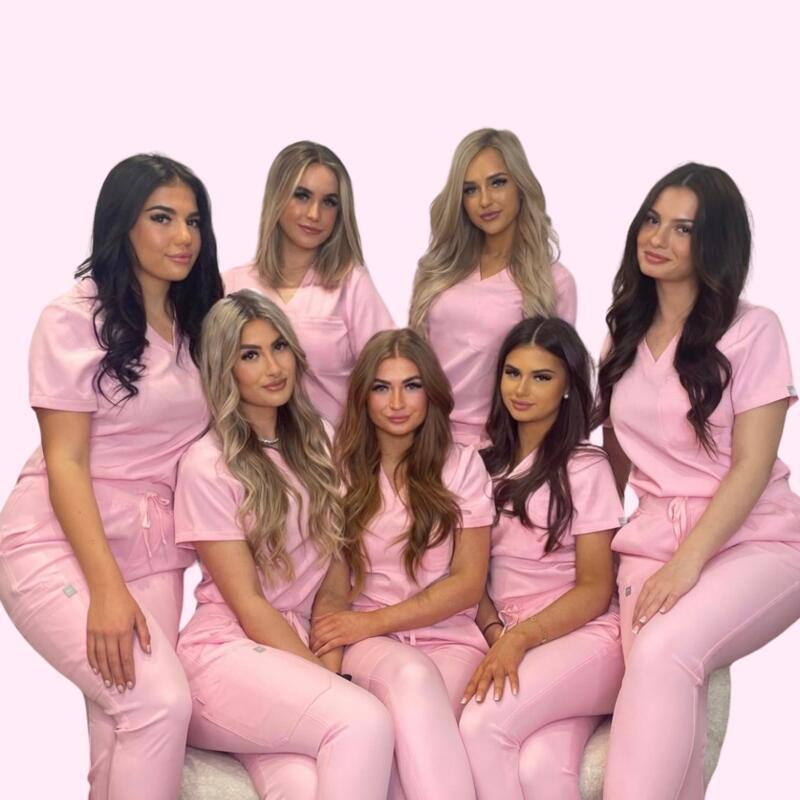 The LBE Artistry team in their pink salon uniforms